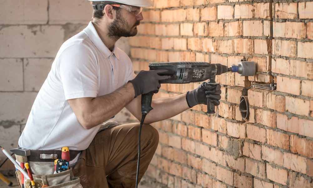 Handyman uses jackhammer, for installation.